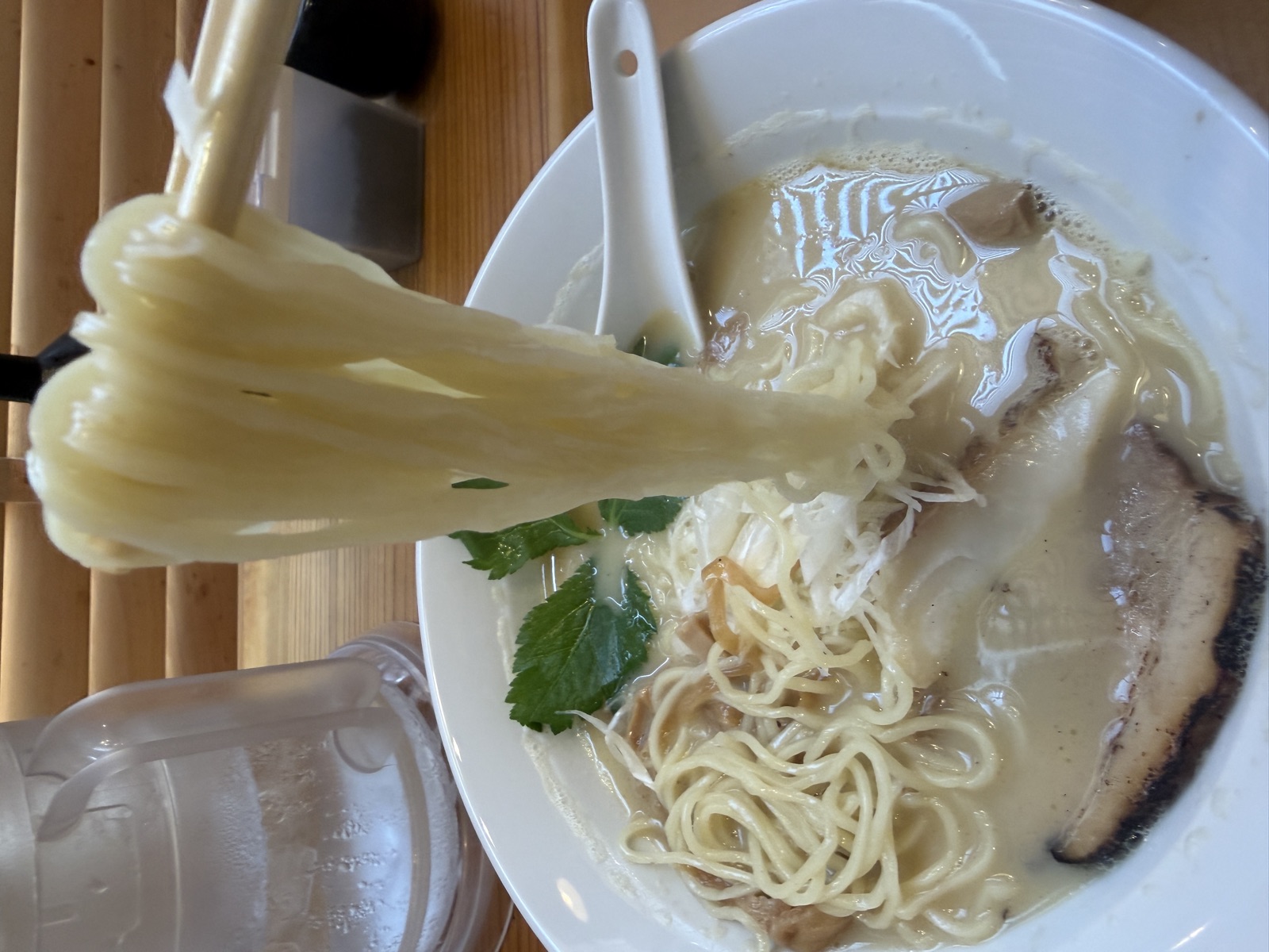 万福久の中太ストレート麺。濃厚な白濁スープをまとっている